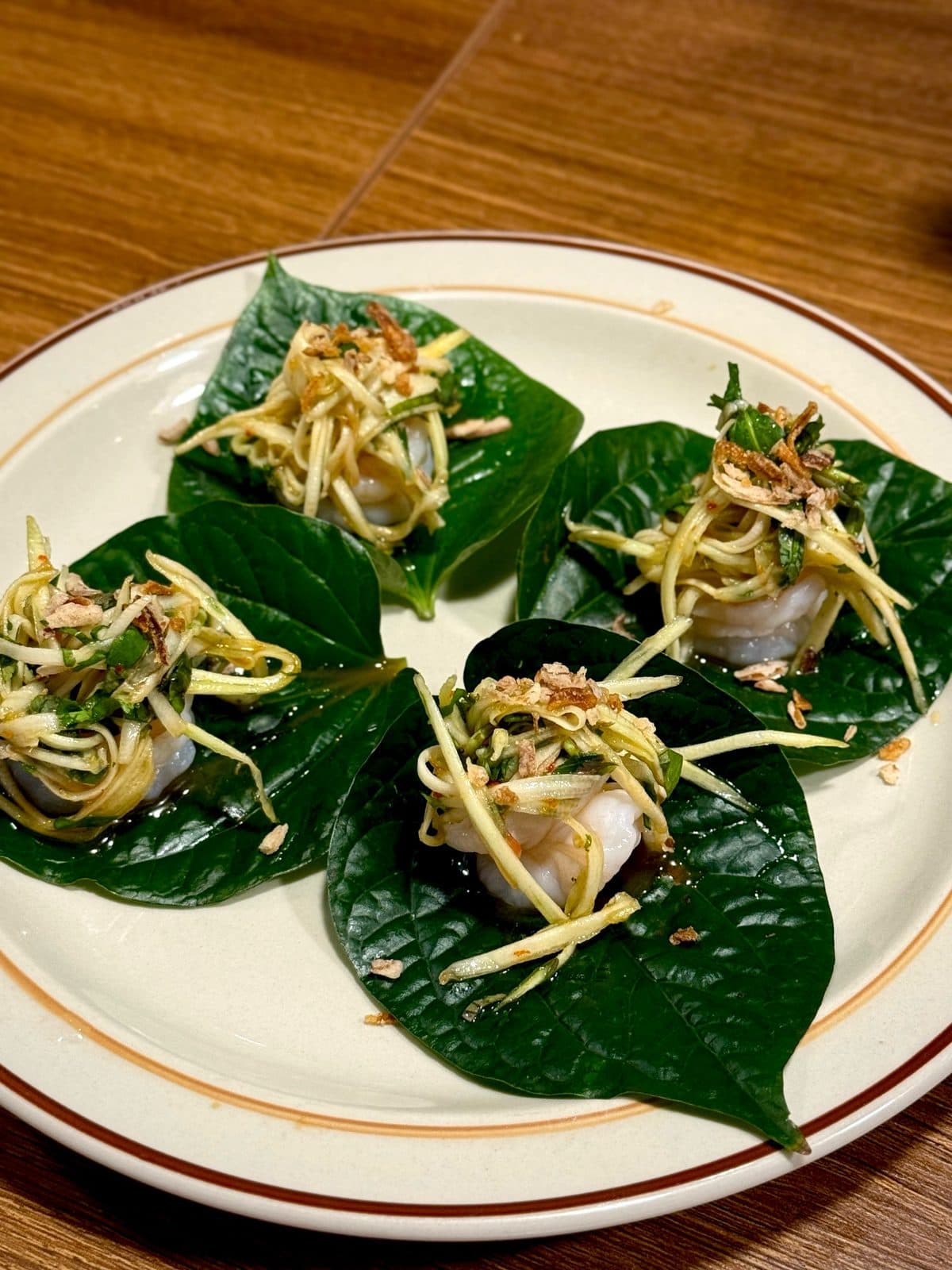 Betel-leaf bites topped with prawn and chilli caramel